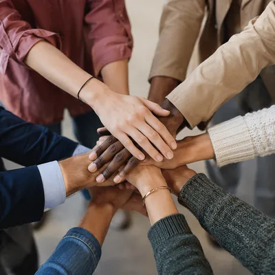 Diverse Team Hands Stacked in Unity