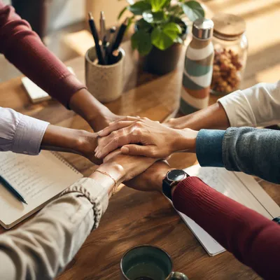Diverse Team Hands Stacked in Unity