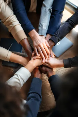Diverse Business Team Hands United Over Table