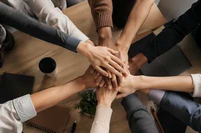 Diverse Team Hands Stacked in Unity
