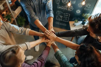 Diverse Team Hands Stacked in Unity