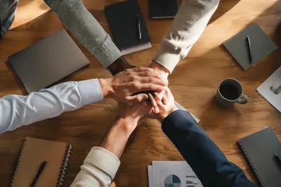 Diverse Team Hands Stacked in Unity