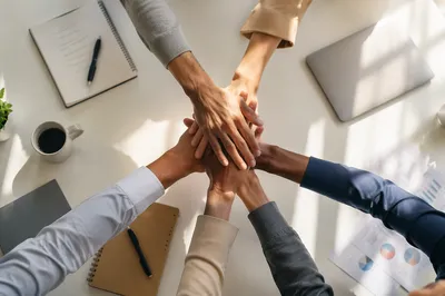 Overhead Team Hands Stacked in Unity
