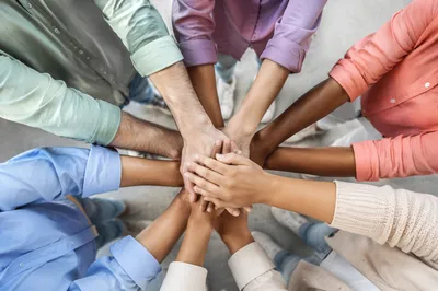 Diverse Team Hands Stacked in Unity