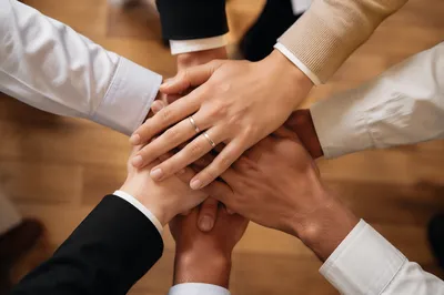 Diverse Business Team Hands Stacked in Unity