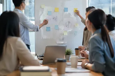Business Team Brainstorming at Whiteboard