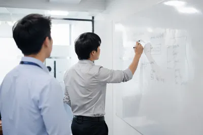 Office Team Brainstorming at Whiteboard