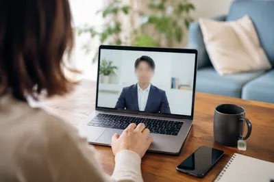 Remote Video Meeting on Laptop Desk