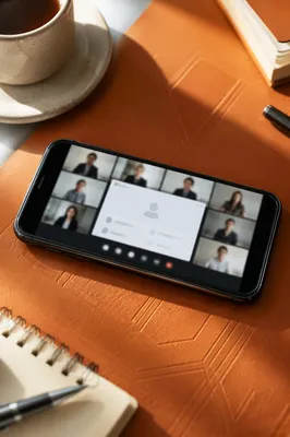 Smartphone Video Conference on Orange Desk
