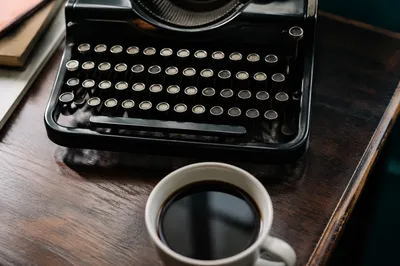 Vintage Typewriter and Coffee on Wooden Desk