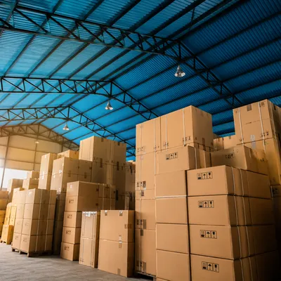 Busy Warehouse with Stacked Shipping Boxes