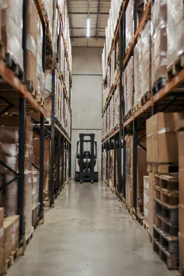 Warehouse Aisle with Forklift and Shipping Boxes