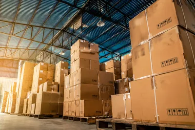 Warehouse Shipping Boxes Under Blue Steel Roof