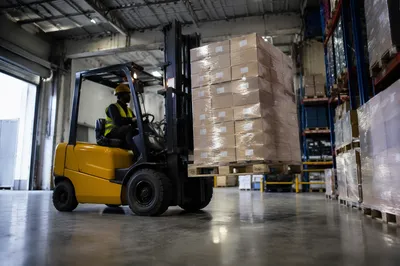 Busy Warehouse Forklift Moving Shipping Boxes