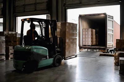 Forklift Moving Shipping Boxes at Loading Dock