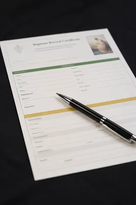 Baptism Certificate and Pen on Desk