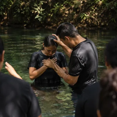 Reverent Outdoor River Baptism in Forest