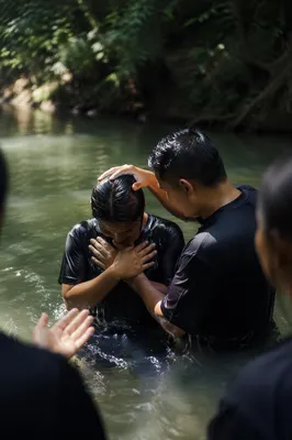 Outdoor River Baptism in Forest Light
