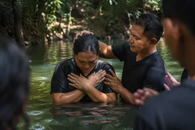 Outdoor River Baptism in Forest Light