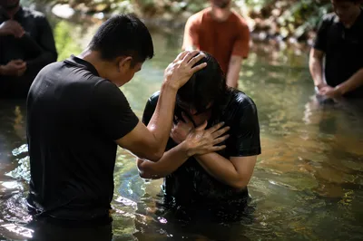 Reverent Outdoor River Baptism Gathering
