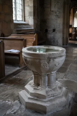 Aged Limestone Baptismal Font in Stone Church