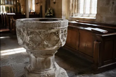 Traditional Stone Baptismal Font in Church
