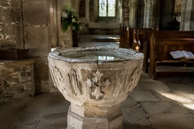 Aged Baptismal Font in Stone Church