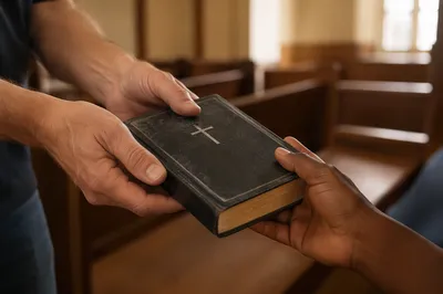 Hands Sharing a Worn Bible in Mission Outreach