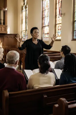Choir Director Leading Rehearsal in Sanctuary