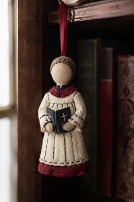 Handmade Choir Singer Ornament on Church Bookshelf