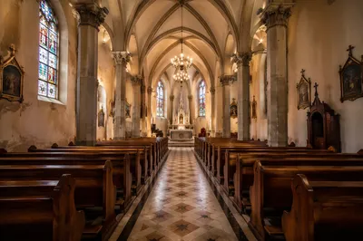 Historic Church Aisle Toward Softly Lit Altar