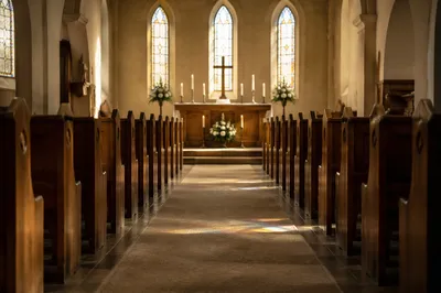 Sunlit Church Aisle Toward Peaceful Altar