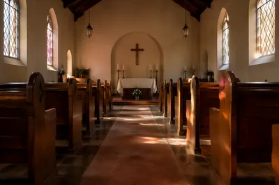 Sunlit Church Aisle Toward Simple Altar