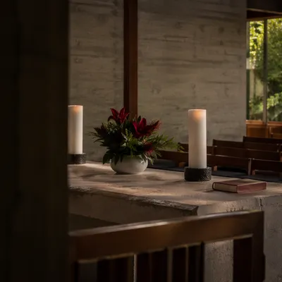 Quiet Church Altar with Flowers and Candles