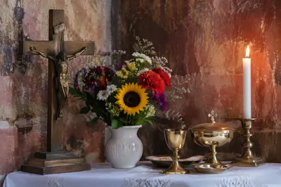 Church Altar Flowers with Candlelight and Crucifix