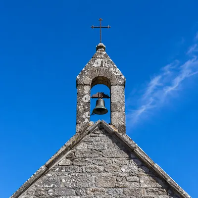 Stone Chapel Bell Tower Under Blue Sky