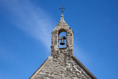 Stone Chapel Bell Tower Under Blue Sky