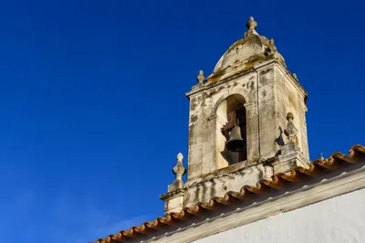 Historic Church Bell Tower Under Blue Sky