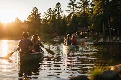 Teens Canoeing at Peaceful Church Camp Lake