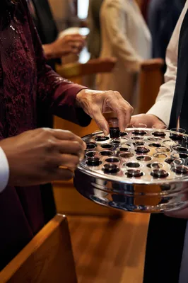 Deacon Serving Communion Cups in Church