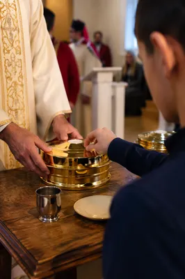 Deacon Serving Communion in Warm Church Light