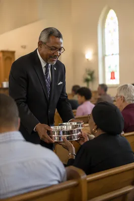 Deacon Serving Communion in Church Sanctuary