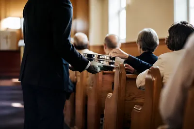 Deacon Serving Communion in Church Sanctuary