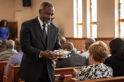 Deacon Carrying Communion Trays in Church
