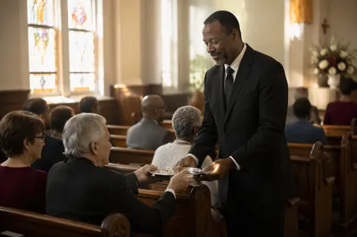 Deacon Serving Communion in Church Sanctuary