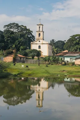 Rural Village Church Beside Reflective Pond