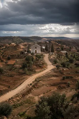 Rural Village Church Under Stormy Skies