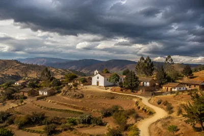 Rural Village Church Beneath Storm Clouds