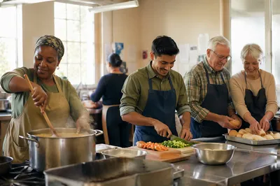 Volunteers Preparing Meal in Bright Kitchen
