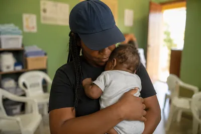 Church Nursery Volunteer Cradling Baby